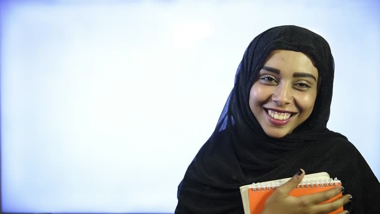 Student holding notebooks, representing education and learning